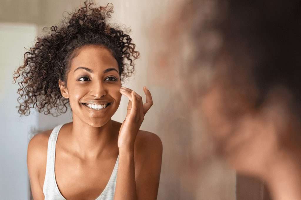 Why Hard Water in Winter Is the Worst 1 woman in mirror