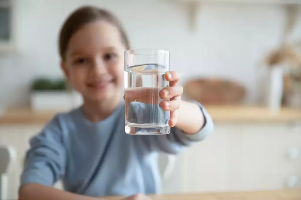 Why Is My Water Softener Full of Water? Causes, Fixes & When to Worry 2 Smiling girl with a glass of water